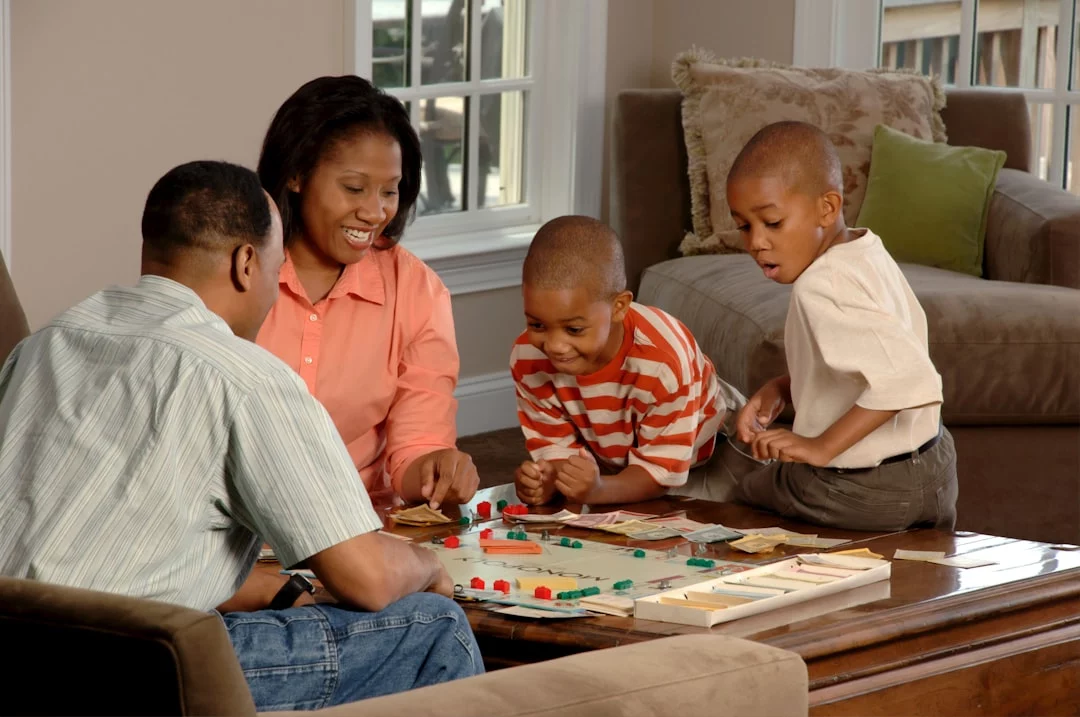Family playing a board game together while practicing rules, turn-taking, and communication