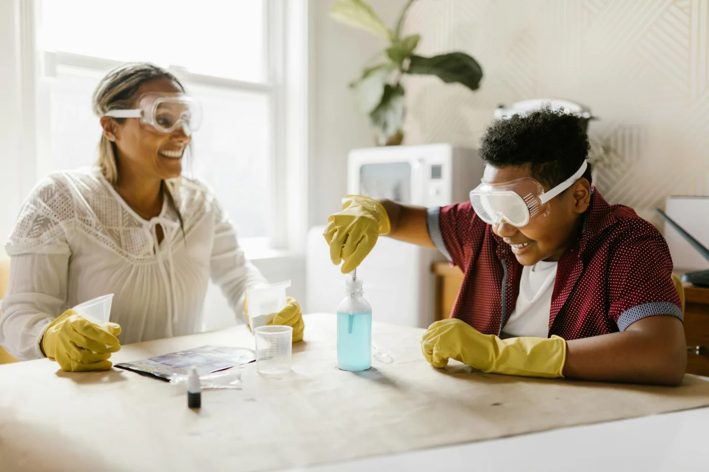 Adult and child recording observations during a home science activity