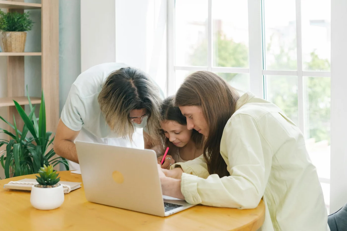 Parents and child reviewing schoolwork together, showing how parents can help with homework without taking over