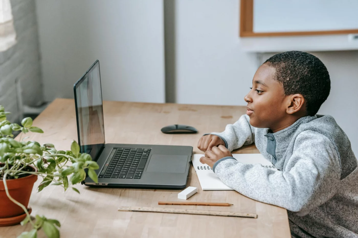 Boy watches an educational video while planning social emotional learning activities for families at home