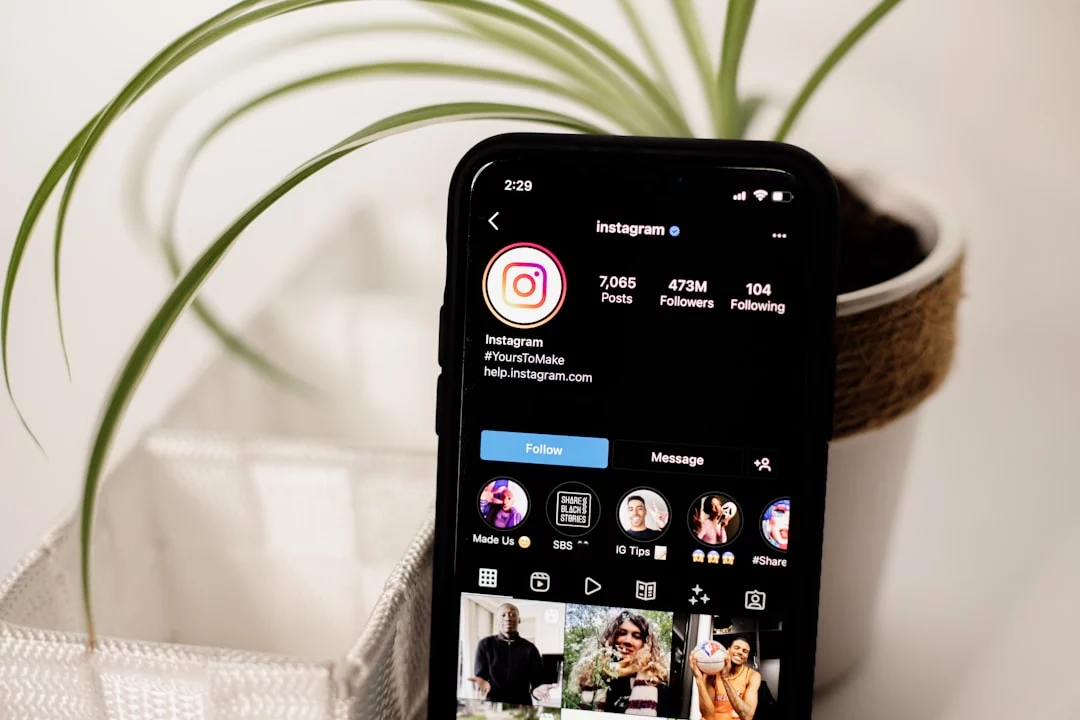 Cell phone on a table beside a potted plant illustrating what are Instagram Instants for parents