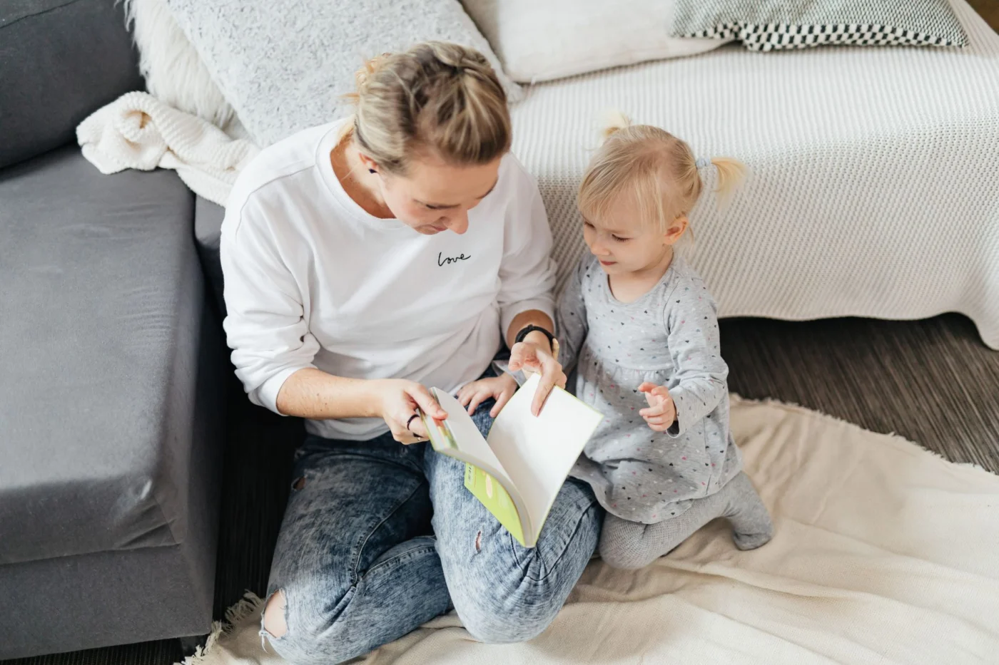 Mother and daughter reading together at home, showing what are the benefits of reading aloud for toddlers