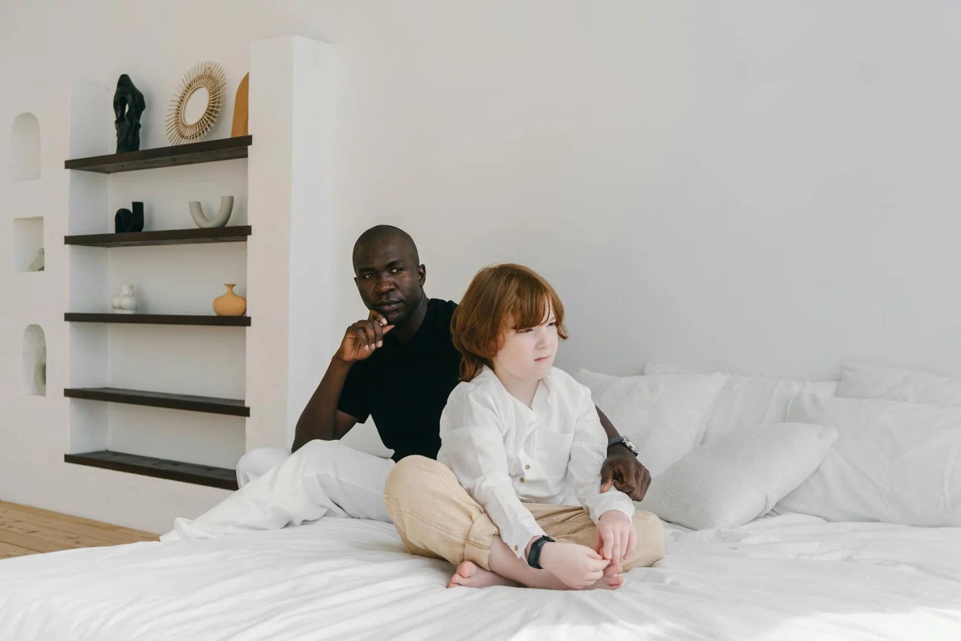 Father comforting his son in a calm bedroom, illustrating what is gentle parenting in everyday family life