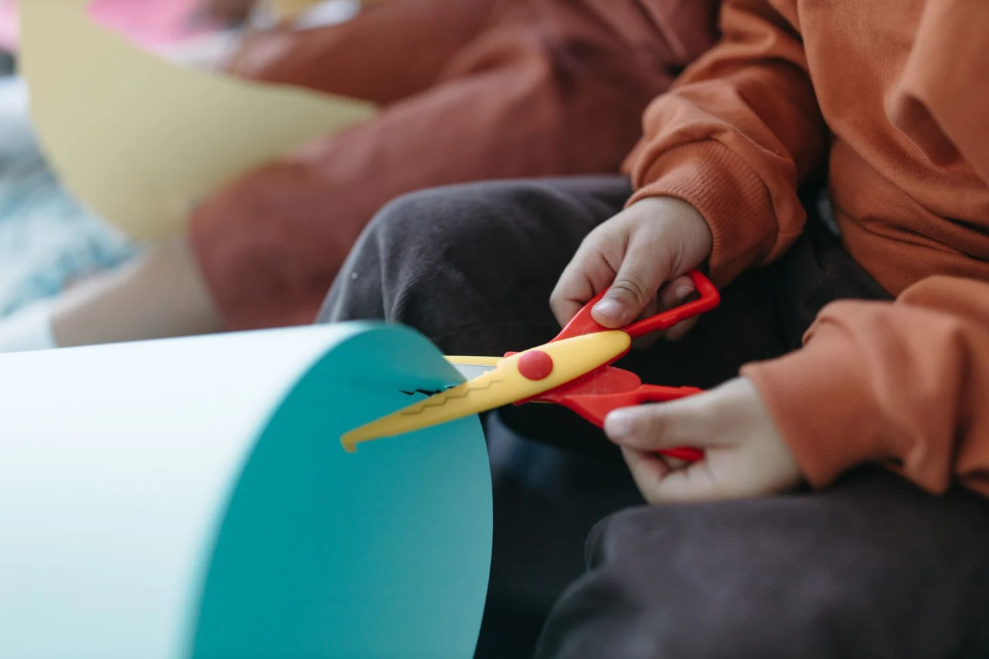 Child using hands during a playful fine motor activity at a table