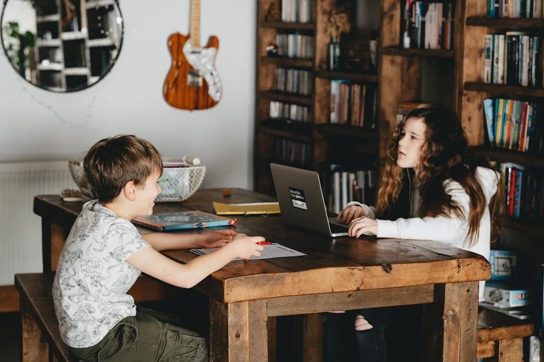 Parent researching homeschool laws on a laptop while planning lessons at home