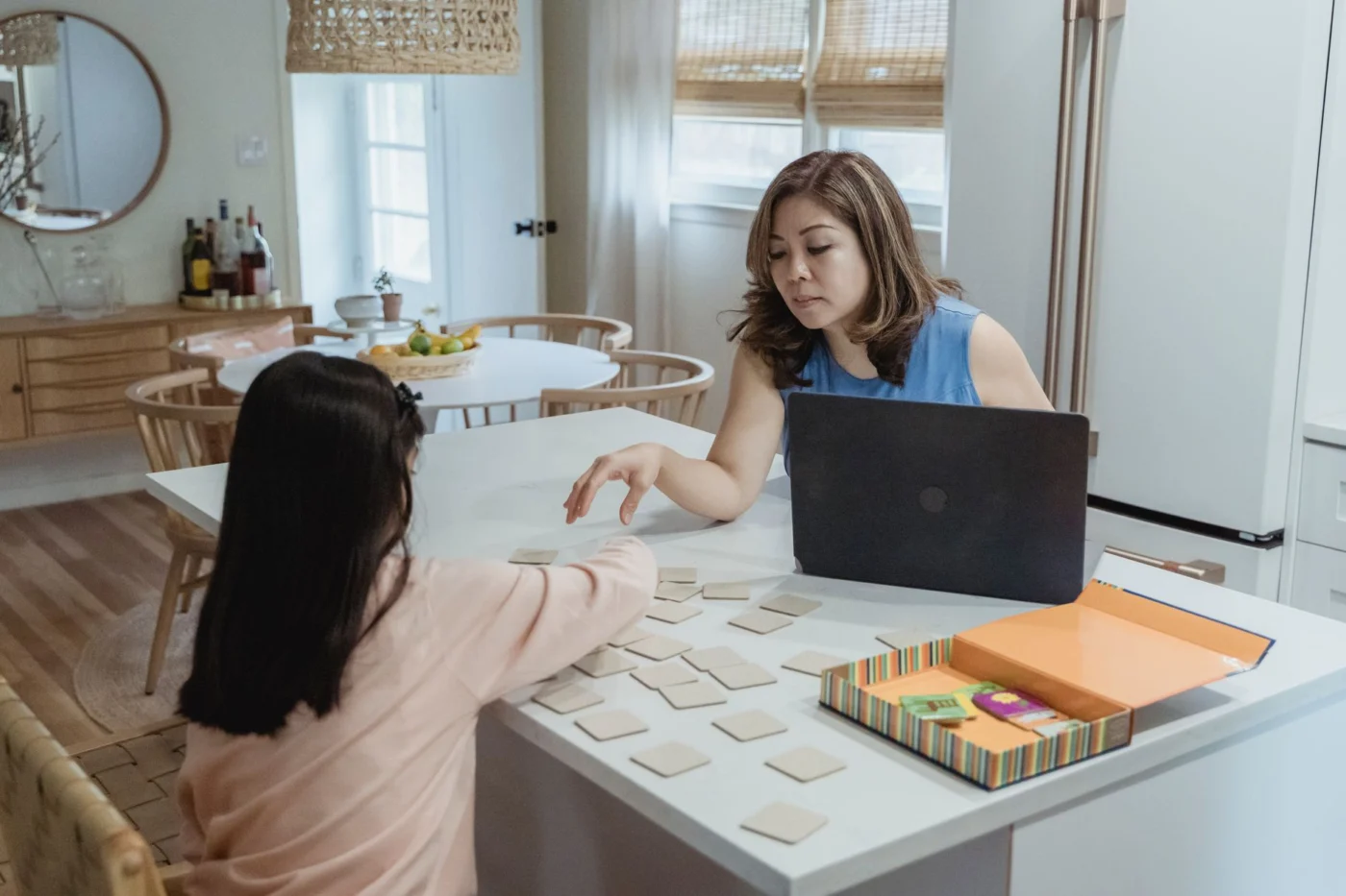 Mother and daughter play a memory game while reviewing homeschool curriculum options